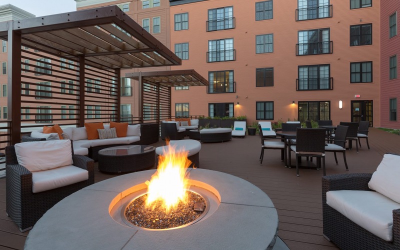 outdoor courtyard area with a firepit, lounge seating and spacious areas