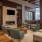 clubroom with modern seating, high-ceilings, a fireplace, wooden accents and modern decor