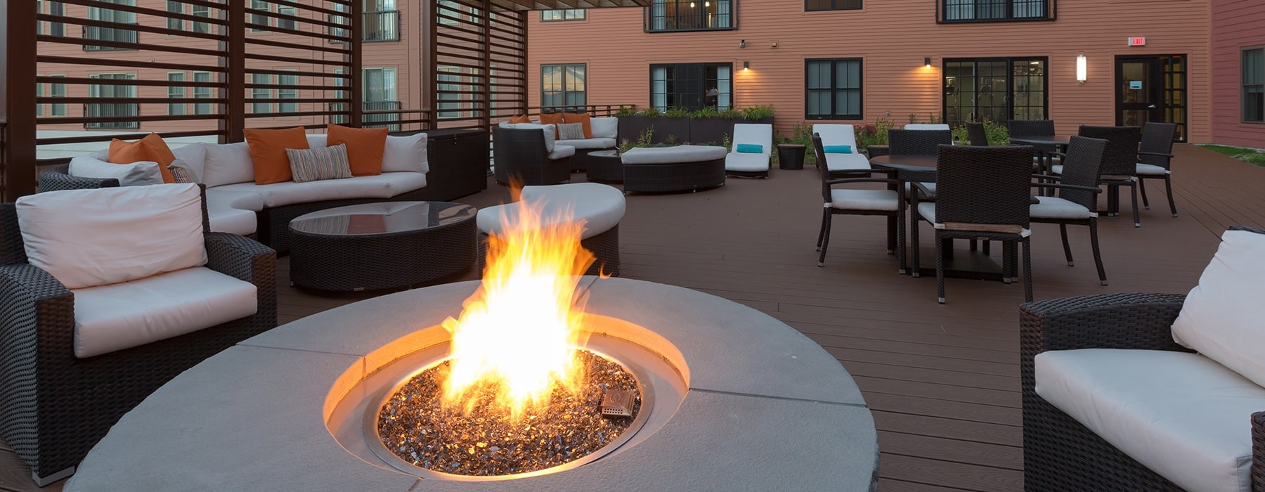 outdoor courtyard area with a firepit, lounge seating and spacious areas